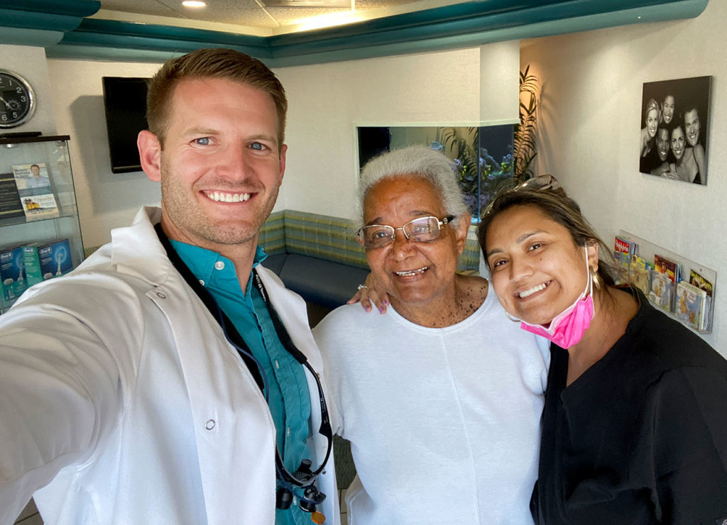 Dr. Colby with patient and assistant after All-on-4